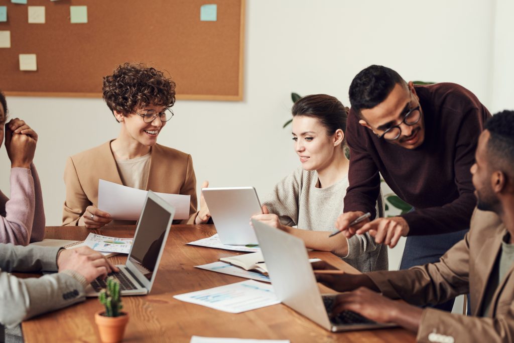 happy employees gathered around a conference table working